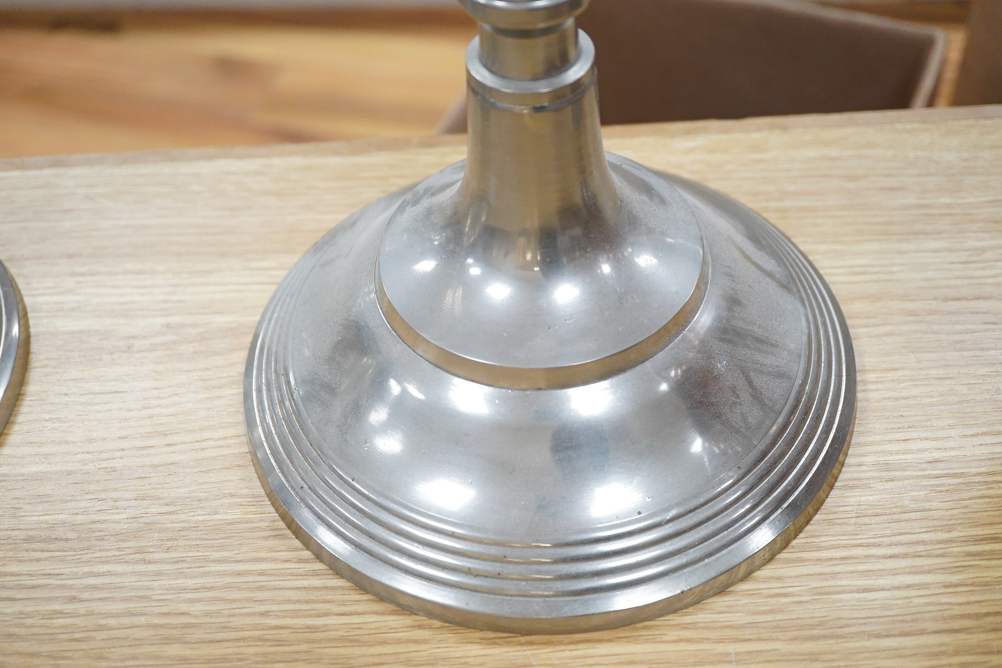 A pair of tall pewter four branch, five light candelabra, 105cm high